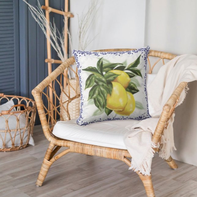 Lemons & Toile Throw Pillow | French Country Charm (White Pillow with large lemons and leaves with a border of Blue Toile Filigree in a wicker chair)