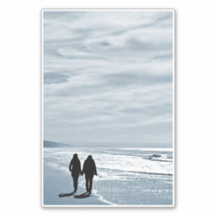 Lesbian Couple Walks Side by Side on a Sandy Beach
