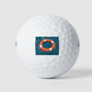 Lifebuoy ring floating on water golf balls