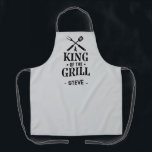 Light Grey Personalized King of The Grill Apron<br><div class="desc">A fun grilling apron with a bold “King of the Grill” graphic and crossed BBQ tools. Add any name under the design to make it personal. The dark background hides spills and the print has that classic backyard-BBQ vibe. Easy gift for dads, uncles, grandpas, and anyone who lives by the...</div>