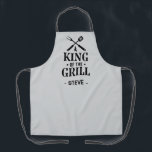 Light Grey Personalized King of The Grill Apron<br><div class="desc">A fun grilling apron with a bold “King of the Grill” graphic and crossed BBQ tools. Add any name under the design to make it personal. The dark background hides spills and the print has that classic backyard-BBQ vibe. Easy gift for dads, uncles, grandpas, and anyone who lives by the...</div>