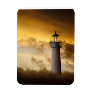 Lighthouse Glowing under Dramatic Sky Magnet