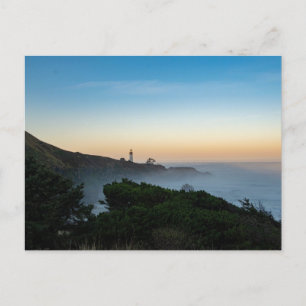 Lighthouse in the early morning, with ocean waves postcard
