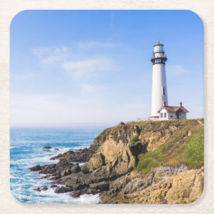 Lighthouse on hill blue sky white house ocean square paper coaster