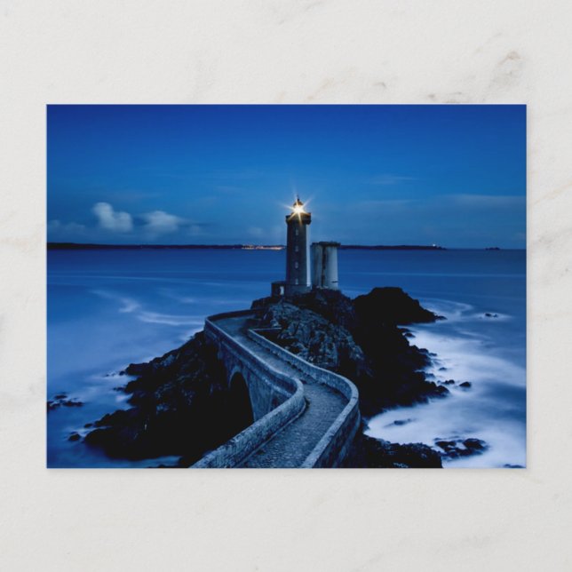 Lighthouse on wall in ocean at night postcard (Front)