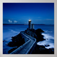 Lighthouse on wall in ocean at night