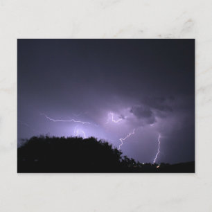 Lightning storm on purple sky postcard