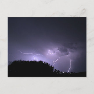 Lightning storm on purple sky postcard
