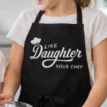 Like Daughter Sous Chef Typography Design Apron<br><div class="desc">This design features a playful white cooking quote on a bold black background, highlighted with elegant script lettering and a small chef hat icon. The phrase “Like Daughter Sous Chef” gives it a fun family-and-kitchen theme that stands out with clean, high-contrast styling. Its mix of flowing typography and simple layout...</div>