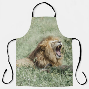 LION LYING ON GREEN GRASS DURING DAYTIME APRON
