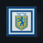 Lion of Judah Emblem Ariel Hebrew 15 Cm Square Badge<br><div class="desc">Square button with an image of a blue and yellow Lion of Judah emblem on white with light blue and dark blue borders and “Ariel” in Hebrew in blue letters above it. See matching square charm, large square premium metal keychain, square double-sided acrylic keychain, round necklace and wrist watch. See...</div>