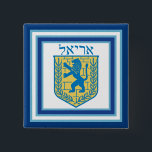 Lion of Judah Emblem Ariel Hebrew 15 Cm Square Badge<br><div class="desc">Square button with an image of a blue and yellow Lion of Judah emblem on white with light blue and dark blue borders and “Ariel” in Hebrew in blue letters above it. See matching square charm, large square premium metal keychain, square double-sided acrylic keychain, round necklace and wrist watch. See...</div>