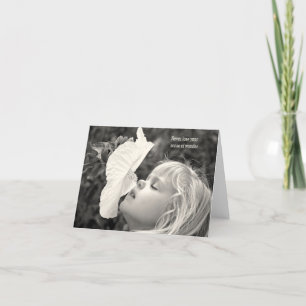 little blond girl sniffing a hibiscus card