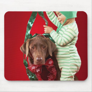 Little boy decorating a dog mouse pad