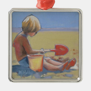 Little boy playing in the sand with a shovel metal tree decoration