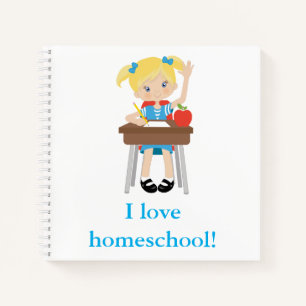 Little girl at desk homeschool notebook