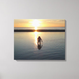 Little Girl Playing at Sunset in Low Tide Water Canvas Print