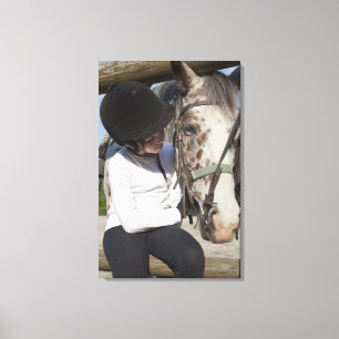 Little girl with her horse canvas print