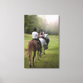 Little girls riding horses canvas print