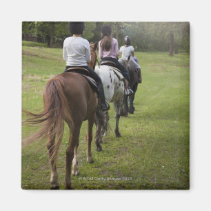 Little girls riding horses magnet