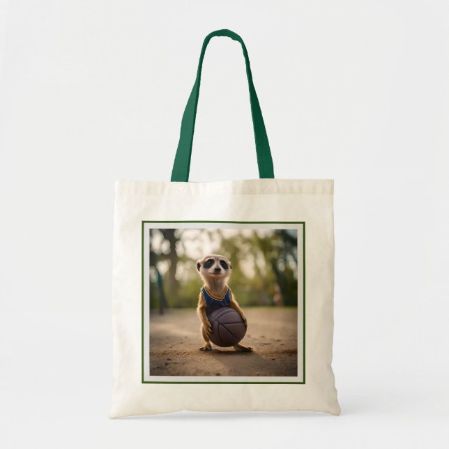 Little Hoop Star: Baby Meerkat Holding Basketball Tote Bag (Front)