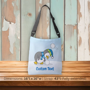 Little penguin getting a snow ball crossbody bag