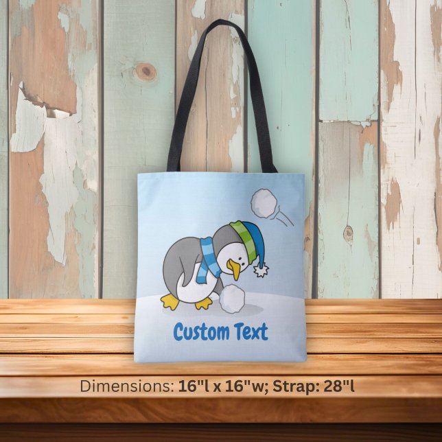 Little penguin getting a snow ball tote bag (Creator Uploaded)