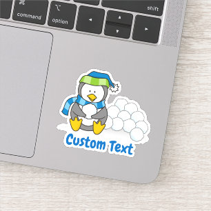 Little penguin sitting with snowballs