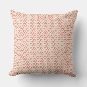 Little red hearts on pastel pink cushion