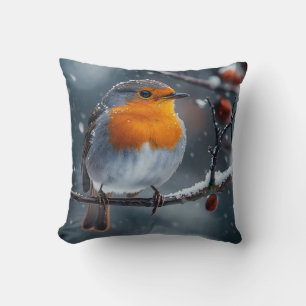 Little robin bird sitting on a branch at winter cushion