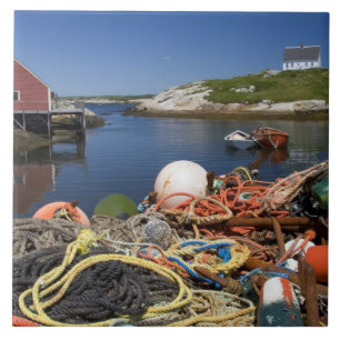 Lobster pots, buoys, and ropes on the dock at tile