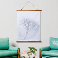 Lonely tree during snow storm in winter