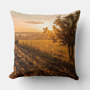 Lonely tree on the foggy field in golden sunrise cushion