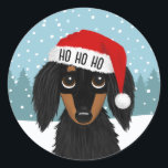 Longhaired Black and Tan Dachshund Santa Christmas Classic Round Sticker<br><div class="desc">Spread holiday cheer with this adorable Christmas dachshund sticker! The sticker features an illustrated longhaired black and tan dachshund wearing a bright red Santa hat with white trim. HO HO HO can be personalised with name or other text. These peel-and-stick stickers can be used to seal envelopes or packages for...</div>