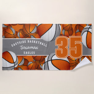 Lots of basketballs with orange grey team colours beach towel