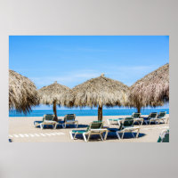 Lounge Chairs And Thatch Umbrellas On Beach