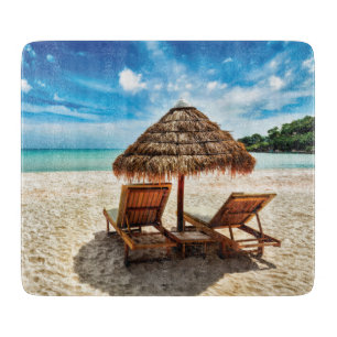 Lounge chairs on beach throw pillow cutting board