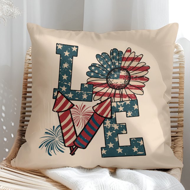 "LOVE" American Flag Independence Day Throw Pillow ("LOVE" American Flag Independence Day Throw Pillow in a sunny rattan armchair.)