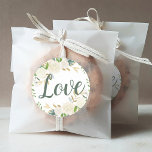 Love Cream Gold Floral Greenery Wedding Classic Round Sticker<br><div class="desc">Wedding favour sticker features "Love" in rich green hand-lettered script writing framed by an elegant floral watercolor design with painted roses,  ranunculus flowers,  and foliage in neutral shades of white,  cream,  blush pink,  gold and green,  Perfect for a spring or summer event.</div>