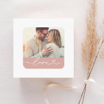 Love Heart Script Custom Muted Pink Wedding Photo Square Sticker<br><div class="desc">Custom wedding envelope seal / favour stickers feature a favourite photo with minimal white "Love" typography overlay design that includes flourish and heart details. Note,  the muted "rose tan" pink coloured background and white text can be customised. A sweet personalised accent for wedding stationery and favours.</div>