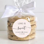Love Is Sweet Pink Wedding Favour Classic Round Sticker<br><div class="desc">Light pink sticker for your wedding candy favours featuring "love is sweet" in clean lettering and a chic script with swashes,  your first names joined together by a heart and your wedding date.</div>