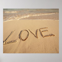 'Love' sand written on the beach with incoming
