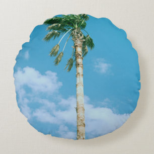Low-angle photo of palm trees under blue sky round cushion