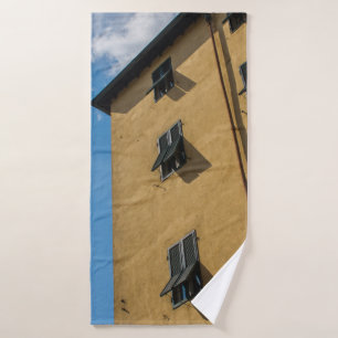LOW ANGLE PHOTOGRAPHY OF BROWN LOUVER WINDOW BATH TOWEL
