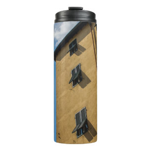 LOW ANGLE PHOTOGRAPHY OF BROWN LOUVER WINDOW THERMAL TUMBLER