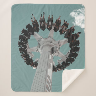 Low-angle photography of people riding a drop-down sherpa blanket