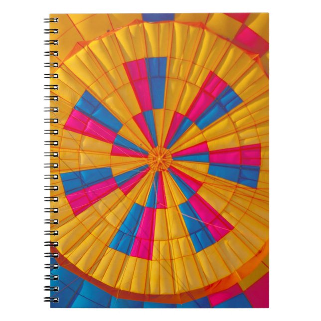 Low angle photography of yellow, pink, and black h notebook (Front)