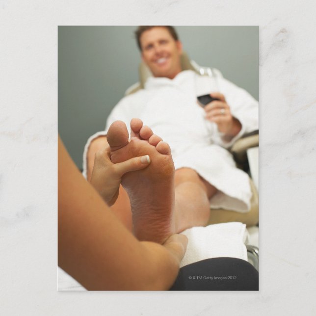 Low angle view of man receiving foot massage postcard (Front)