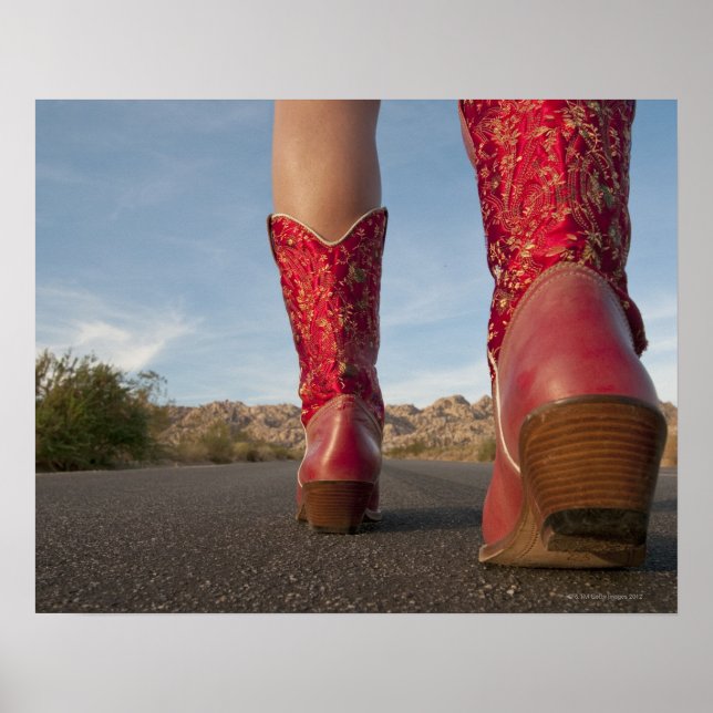 Low-angle view of woman wearing cowboy boots poster (Front)
