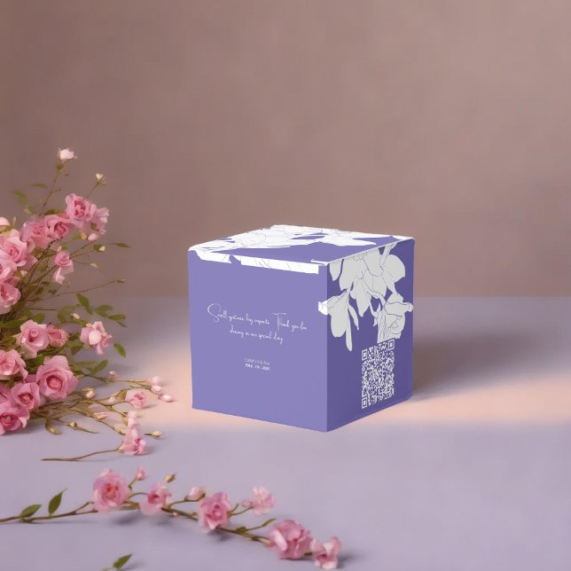 Luxury purple flowry  favour box (a purple floral favor box with a white flowers placed on soft surface surrounded with pnik flowers)